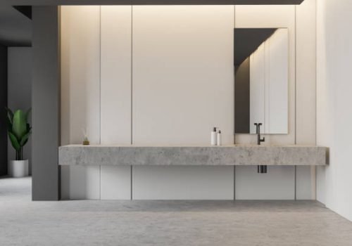 Interior of spacious bathroom with white and gray walls, stone sink on long counter with mirror above it and potted plant. 3d rendering