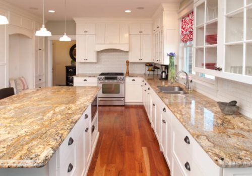 This spacious kitchen features marble counters and center counter, stunning hardwood cabinets and floor.