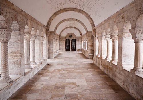 Travertine hallway with arch in the monastery