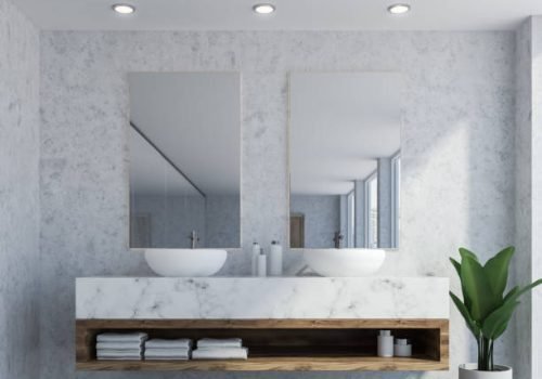 Bathroom interior with marble walls, a double sink standing on white countertops and a two vertical mirrors hanging above it. A close up 3d rendering